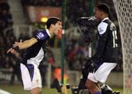 Liverpool's Luis Suarez celebrates after scoring his second goal with Daniel Sturridge.